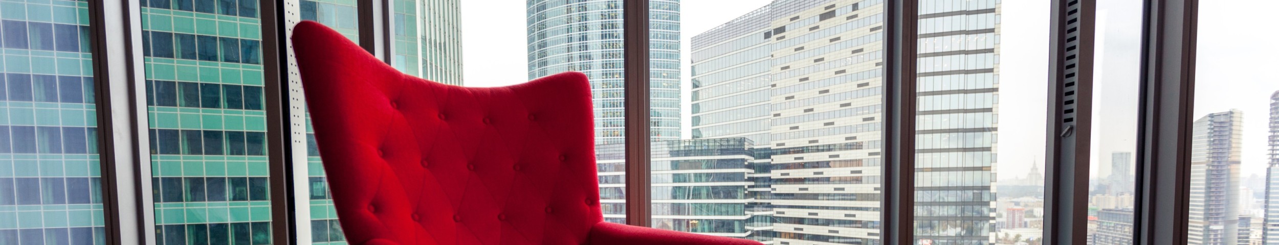 Red armchair in highrise building